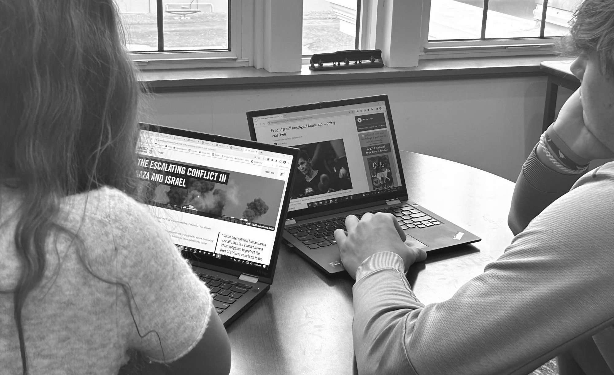 Mikaela Mikulec '24 and Mason Swartz '24 read the news about the Israel-Hamas war