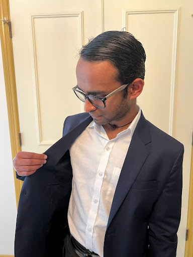 Fixing his blazer, Omkaar Alakkassery ‘24 wears his graduation attire in his home prior to the commencement ceremony. At MICDS, young men often wear navy blazers and dark gray trousers to fulfill the school’s graduation attire requirements. 
