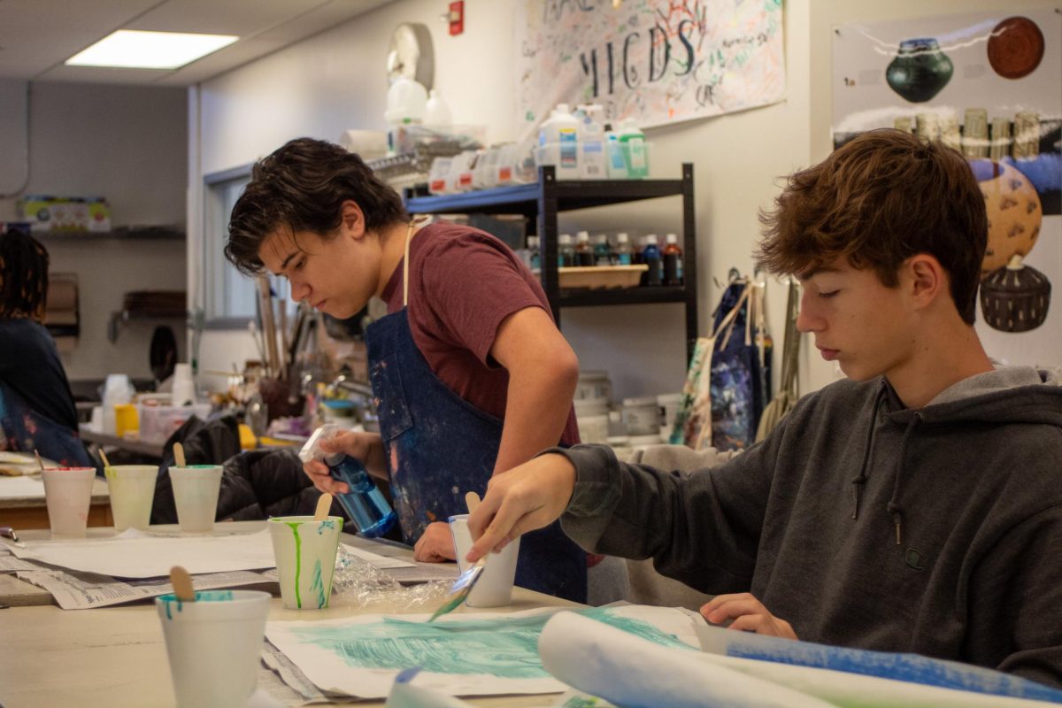 Printmaking class students Grant Krainik ‘27 and Spencer Levison ‘28 engage in the making of individual print books.