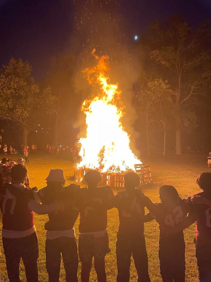 Celebrating the traditions of Homecoming, football players watch the bonfire in 2024. 
