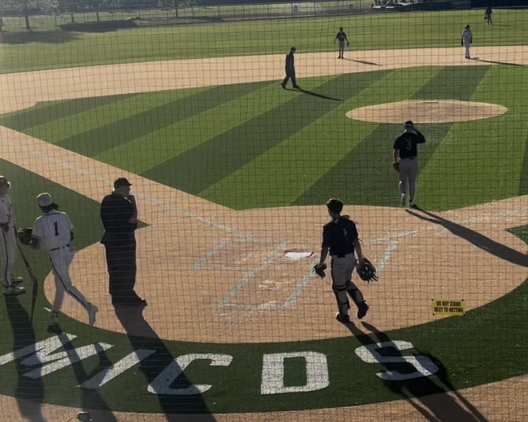 Scoring a run at the end of a game on April 17 against Parkway North, LJ Triplett greets teammate at home plate.