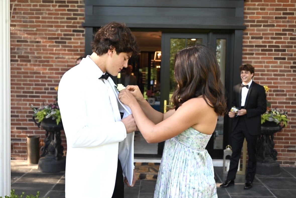 Pinning the boutonniere onto her date, Amelia Mackin ‘26 heads to prom with Steele Crissman ‘26 on April 18. 
