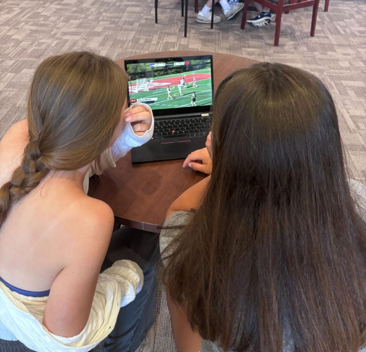 Varsity Lacrosse Players Amelia Mackin ‘26 and Kennan Miller ‘28, watch film on April 30, preparing for a game vs Marquette.