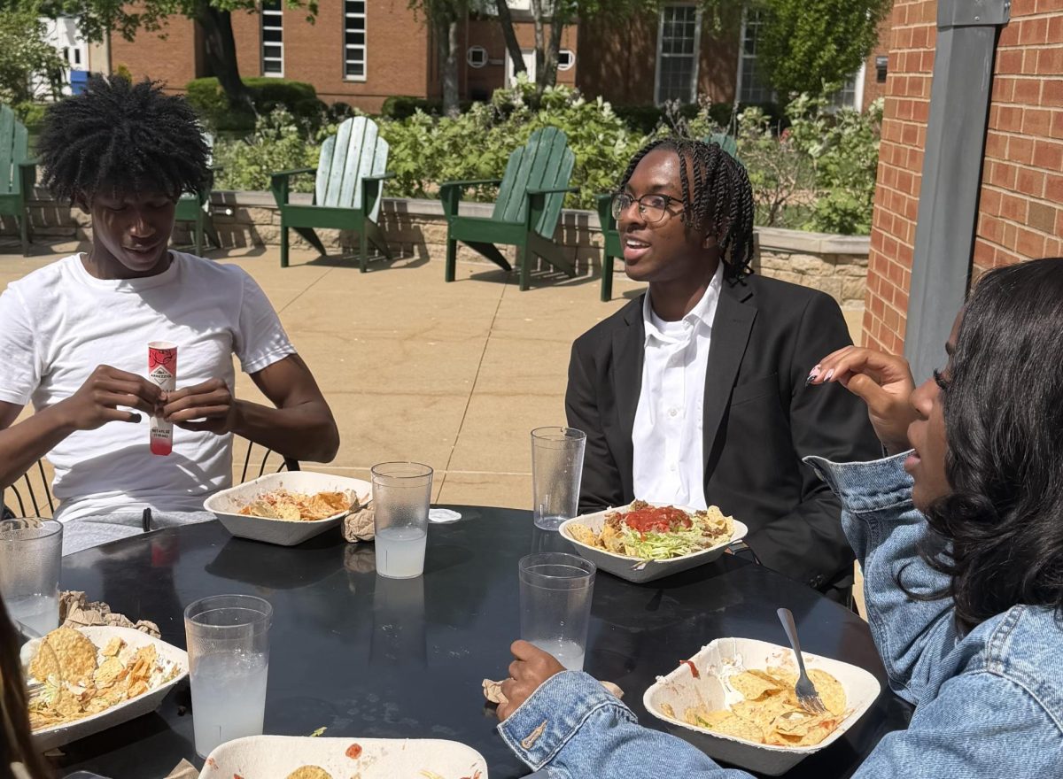 Dining al fresco from the Dining Hall, Sebastian Harris ‘26, talks with Riley Crawford '26, and Jason Stokes ‘26 on April 21.